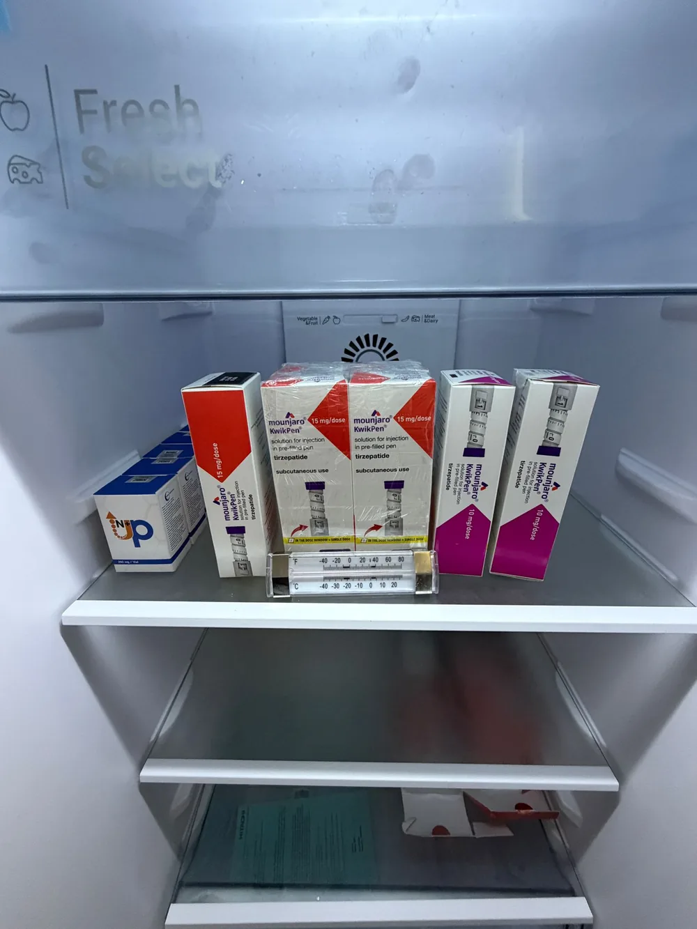 Authentic GLP-1 pens and NAD+ stored with a fridge thermometer inside the 2–8°C (36–46°F) cold-chain at the TRT Bangkok Clinic in Pattaya