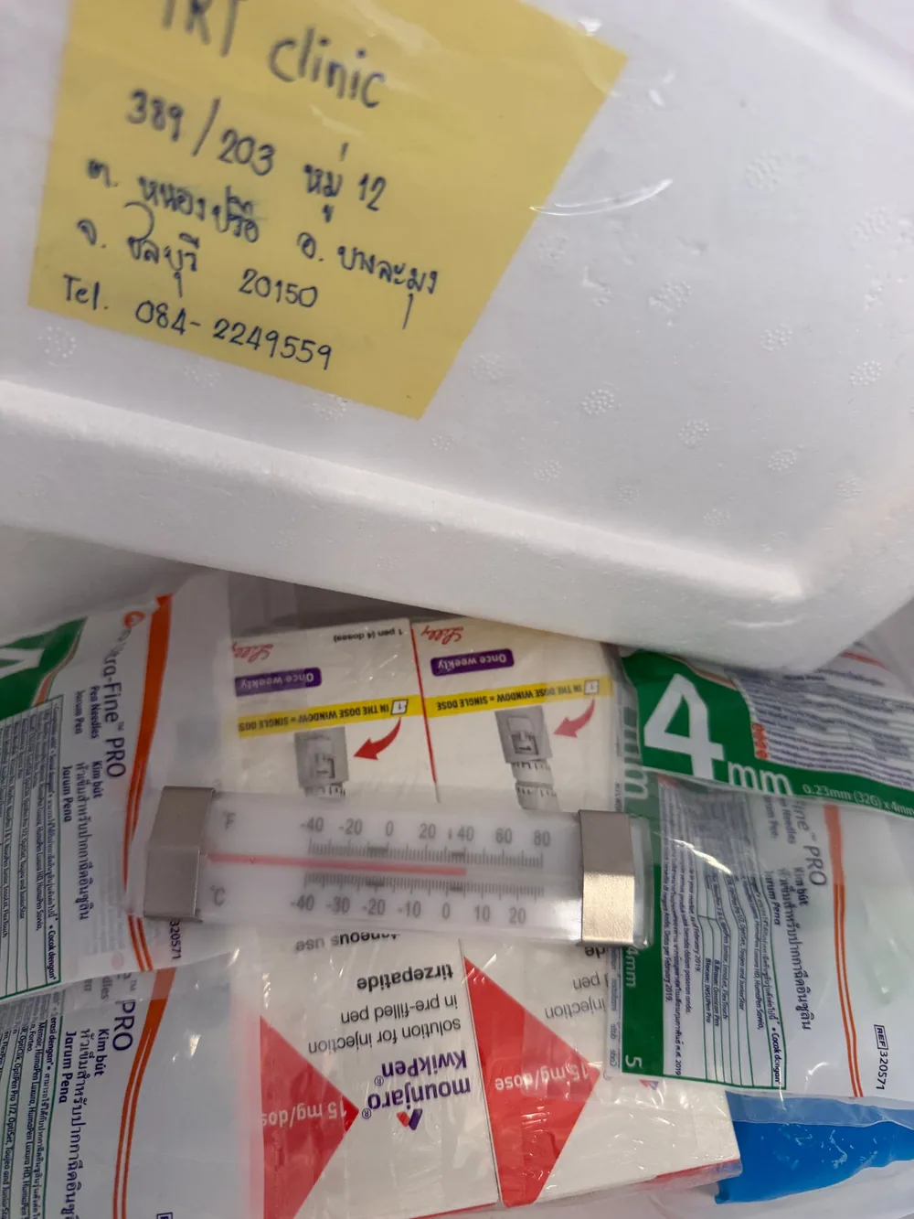 Cold-chain box labelled to the TRT Bangkok Clinic on Pratumnak Hill, Pattaya, with a fridge thermometer inside the 2–8°C (36–46°F) range
